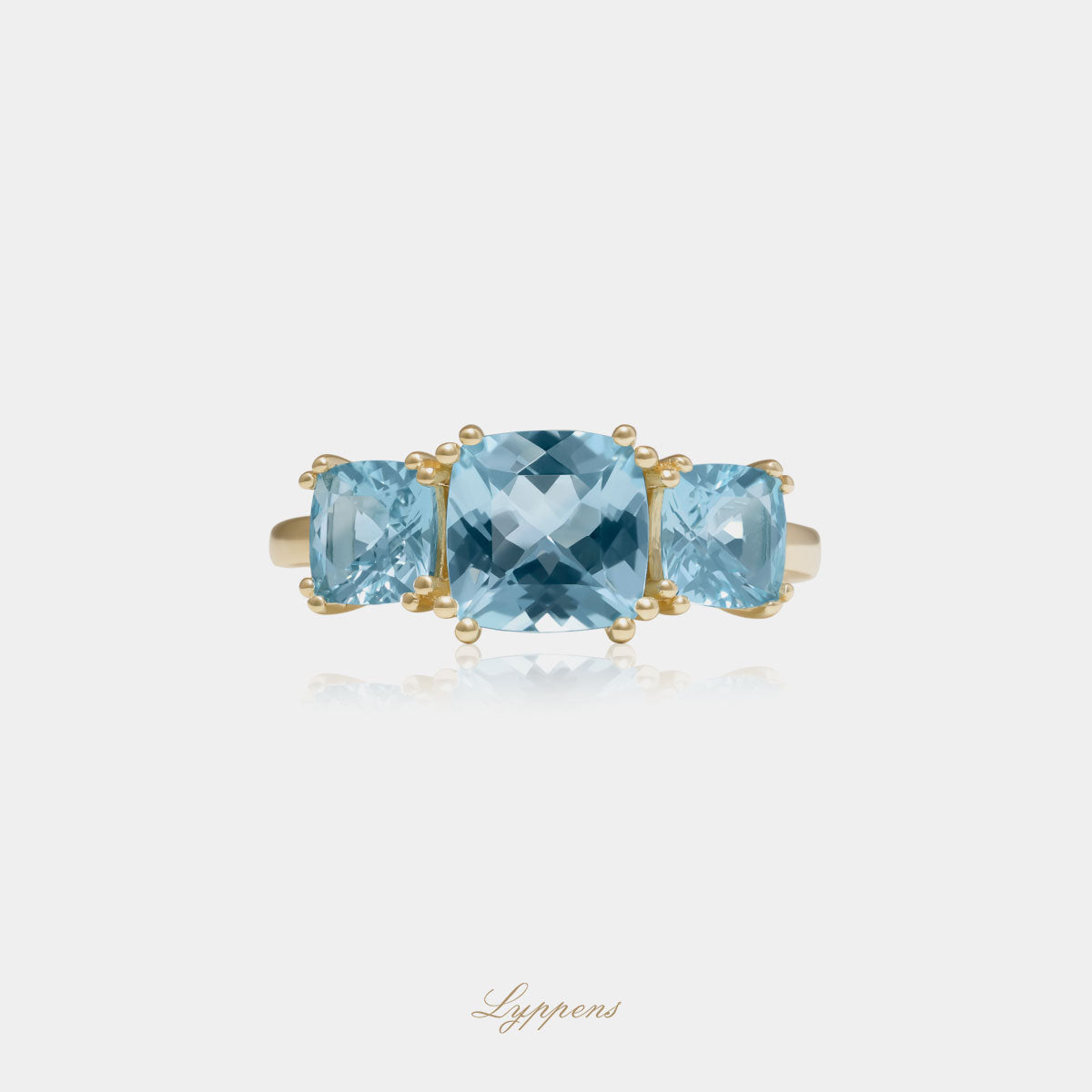 Yellow gold three stone ring with topaz