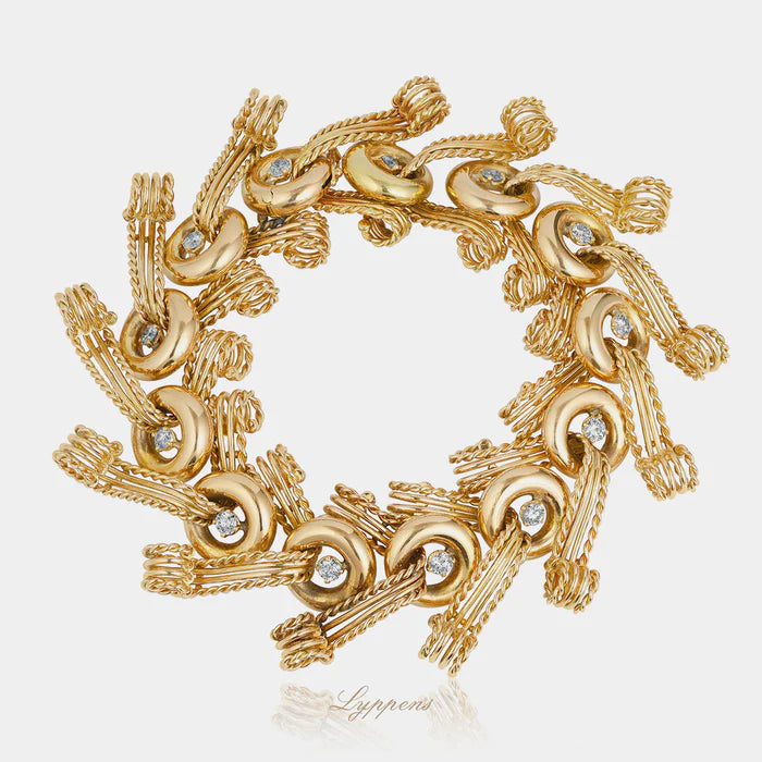 18 karaat geelgouden Franse vintage armband uit de jaren 50 met sierlijke cirkels, krullen en briljant geslepen diamanten.