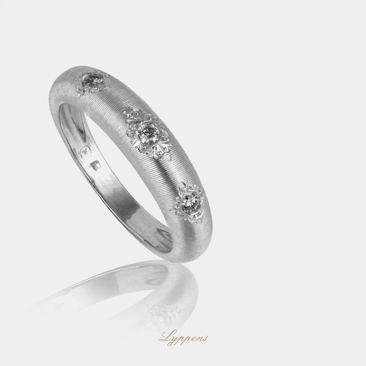 White gold three-stone ring with diamonds