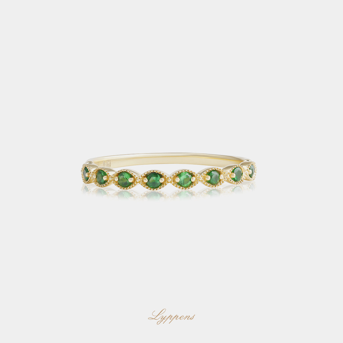 Yellow gold half eternity ring with tsavorite