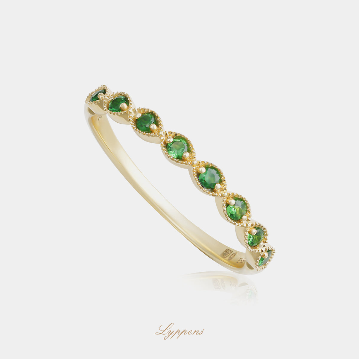 Yellow gold half eternity ring with tsavorite