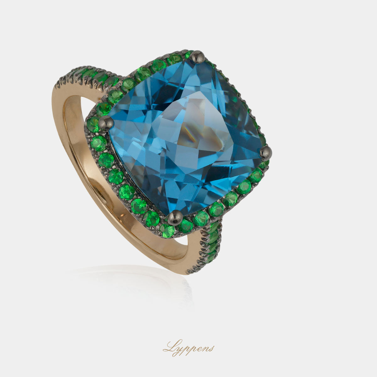 Rose gold entourage ring with topaz and tsavorite