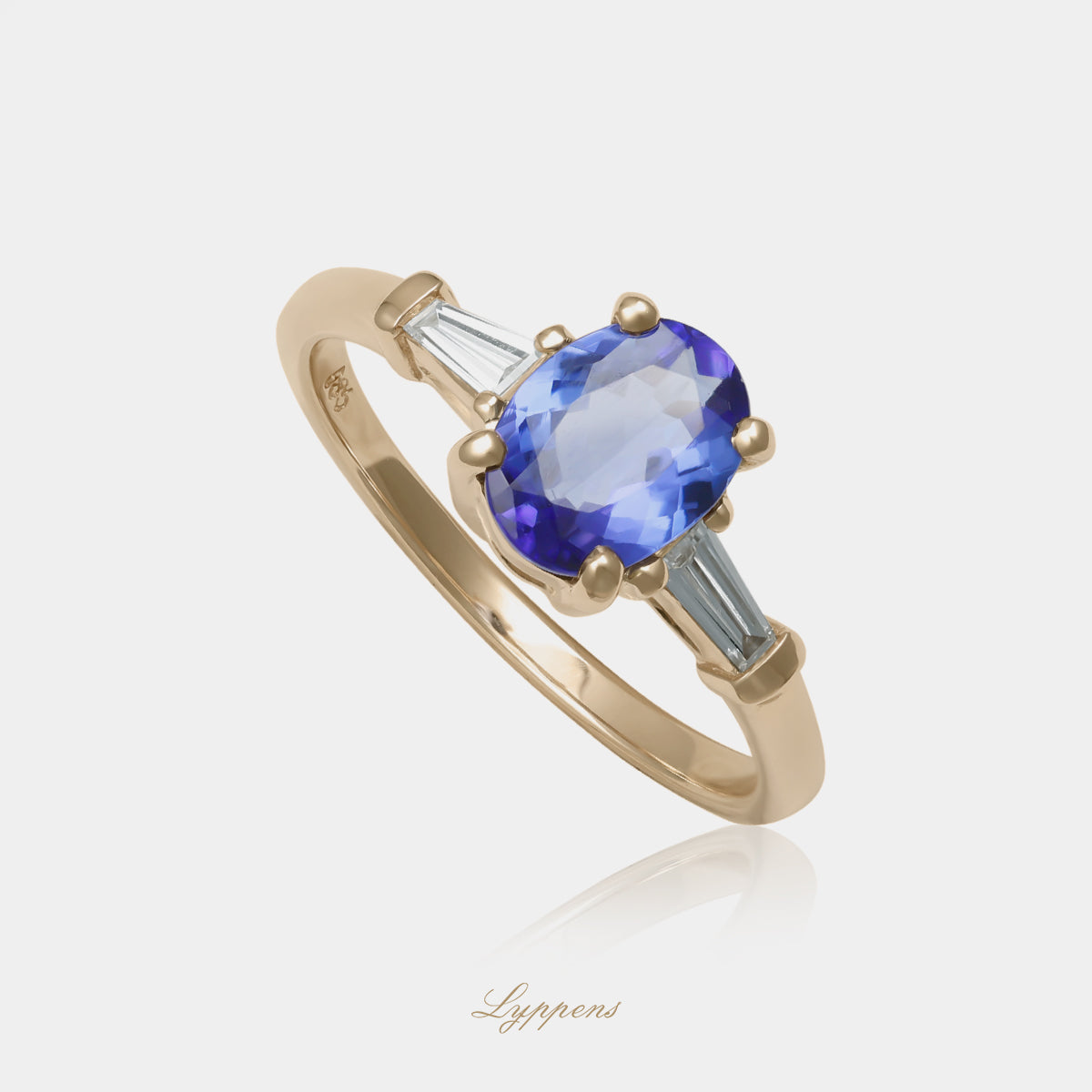 14kt geelgouden verlovingsring met tanzaniet en tapered baguette diamanten