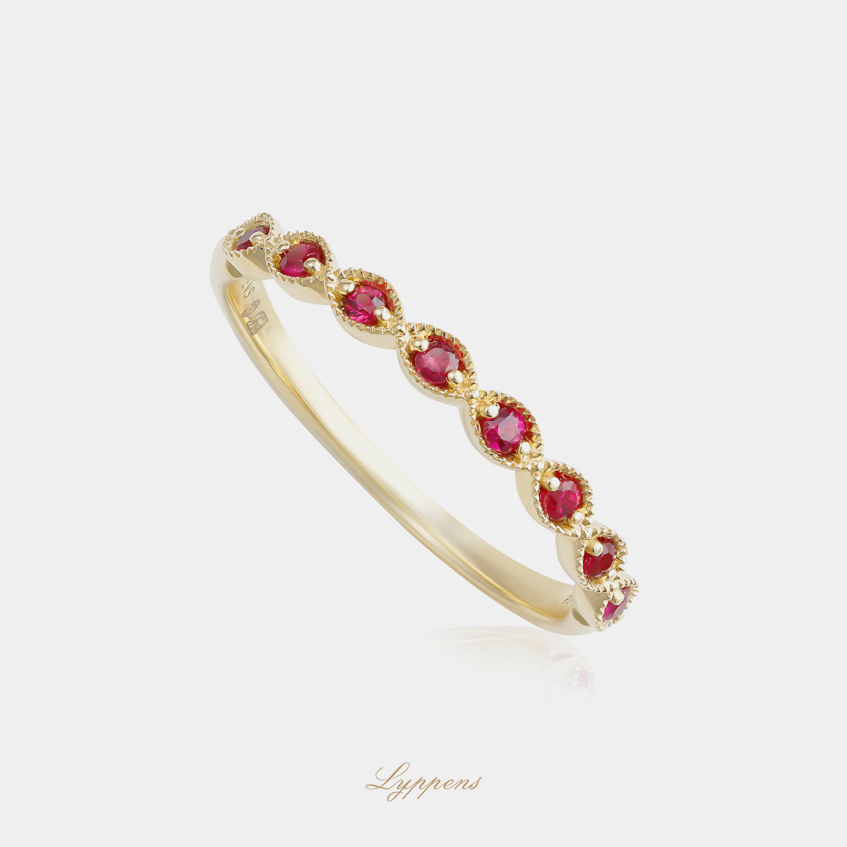 Yellow gold half eternity ring with rubies