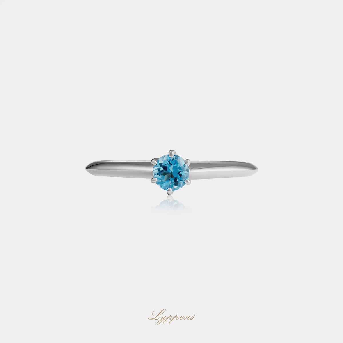 White gold solitaire ring with topaz