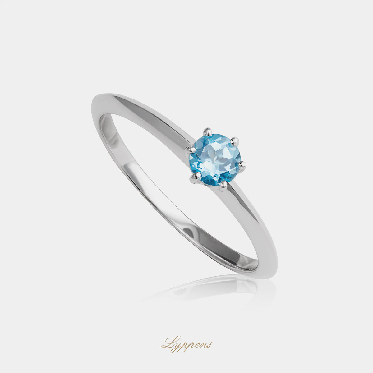 White gold solitaire ring with topaz