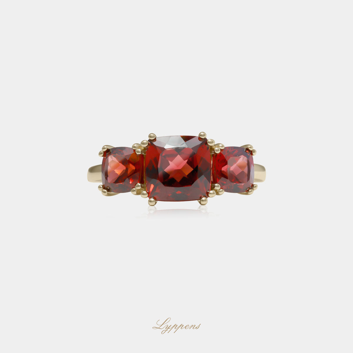 Yellow gold three stone ring with garnet