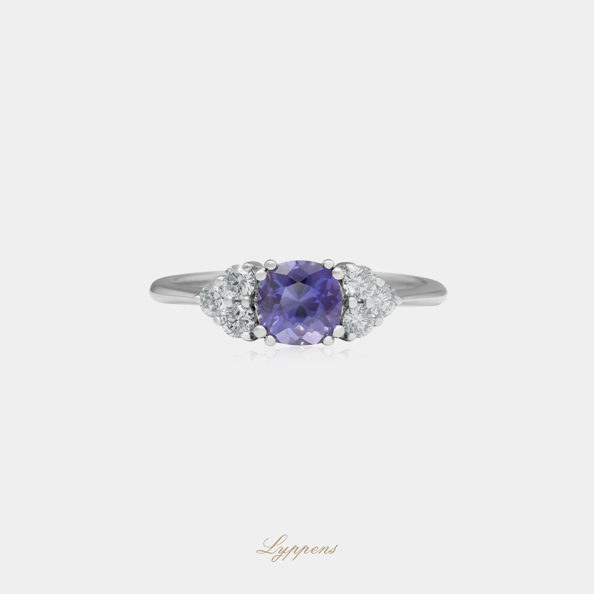 Witgouden ring in het midden gezet met een rond geslepen paarse saffier en geflankeerd door briljant geslepen diamant.