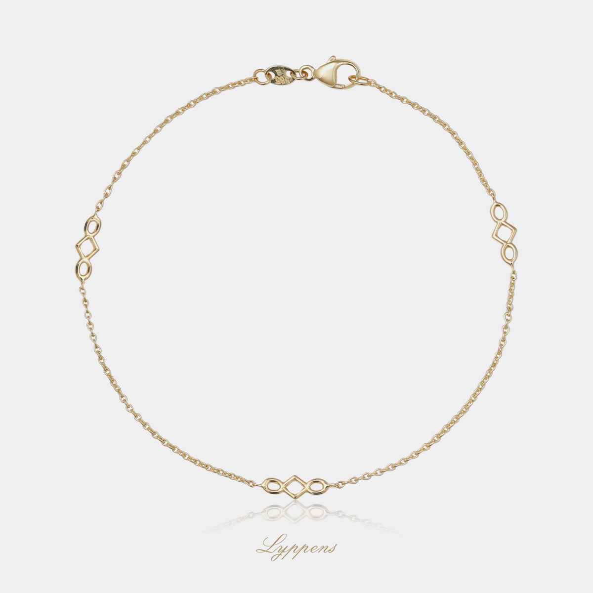 Geelgouden anker schakelarmband met drie gouden elementen.