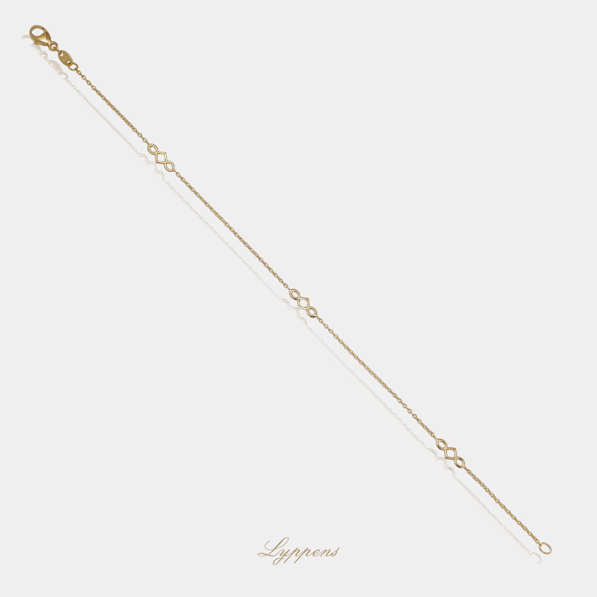 Geelgouden anker schakelarmband met drie gouden elementen.