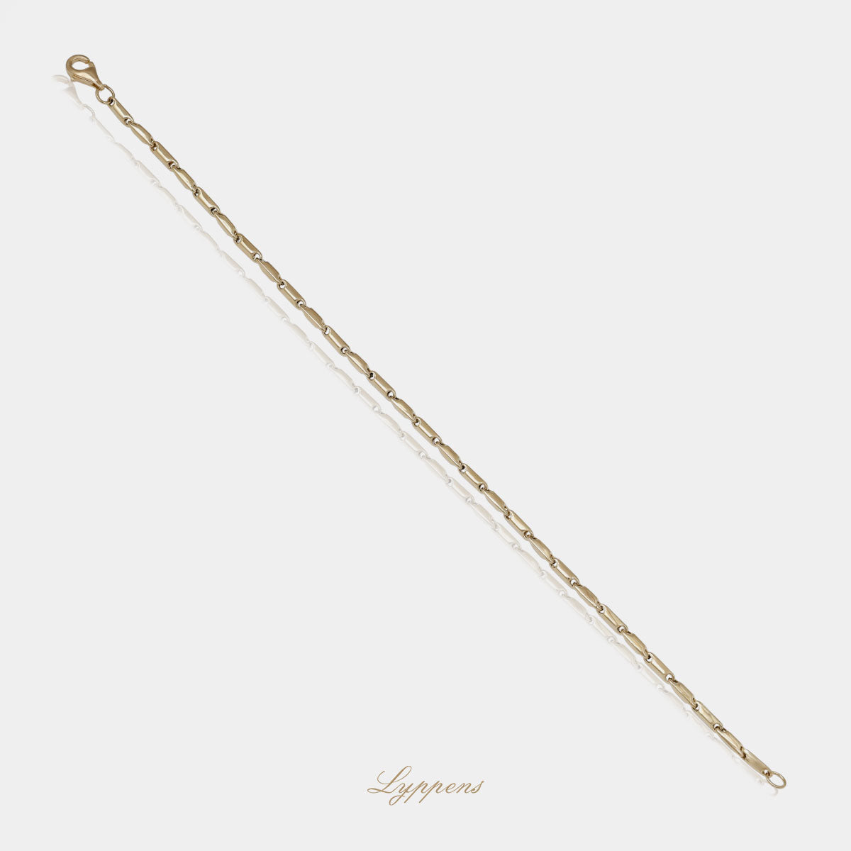 Geelgouden schakelarmband met fantasie schakel.