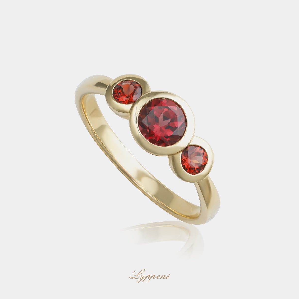 Yellow gold three-stone ring with garnet