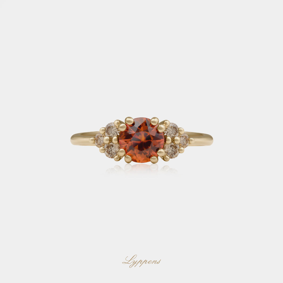 18kt geelgouden ring in het midden gezet met een oranje saffier geflankeerd door briljant geslepen bruine diamant.