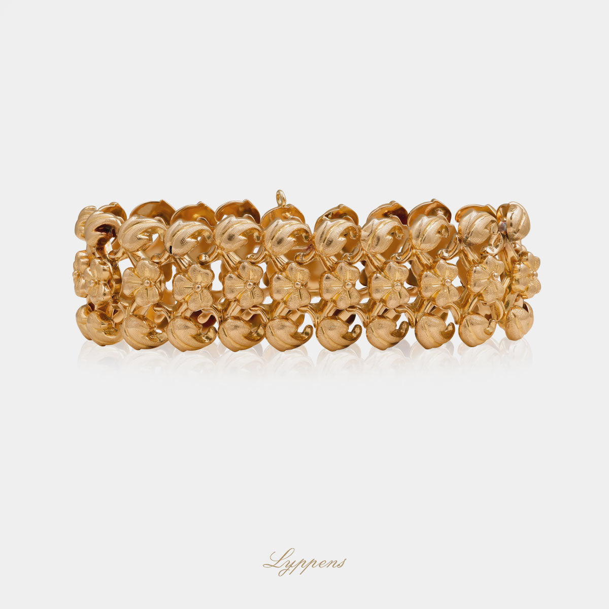14kt roségouden vintage jaren ’50 schakelarmband met gematteerde schakels en bloem- en bladmotief.
