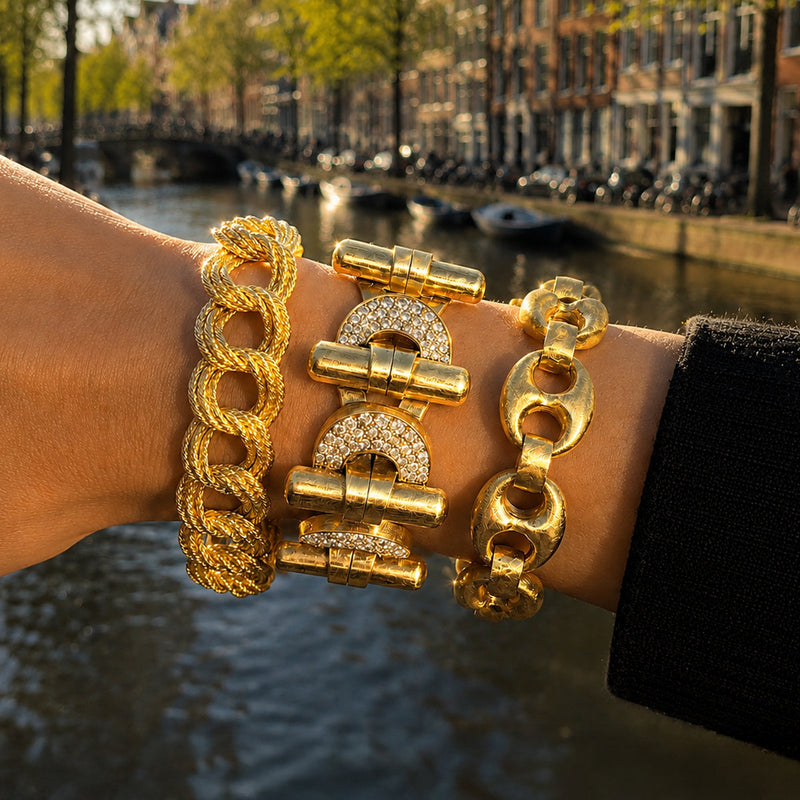 Twee vintage armbanden op de kade in Amsterdam: een roségouden jaren ’40 tank armband met ovale schakels en een geelgouden jaren ’50 schakelarmband met briljant geslepen diamanten.