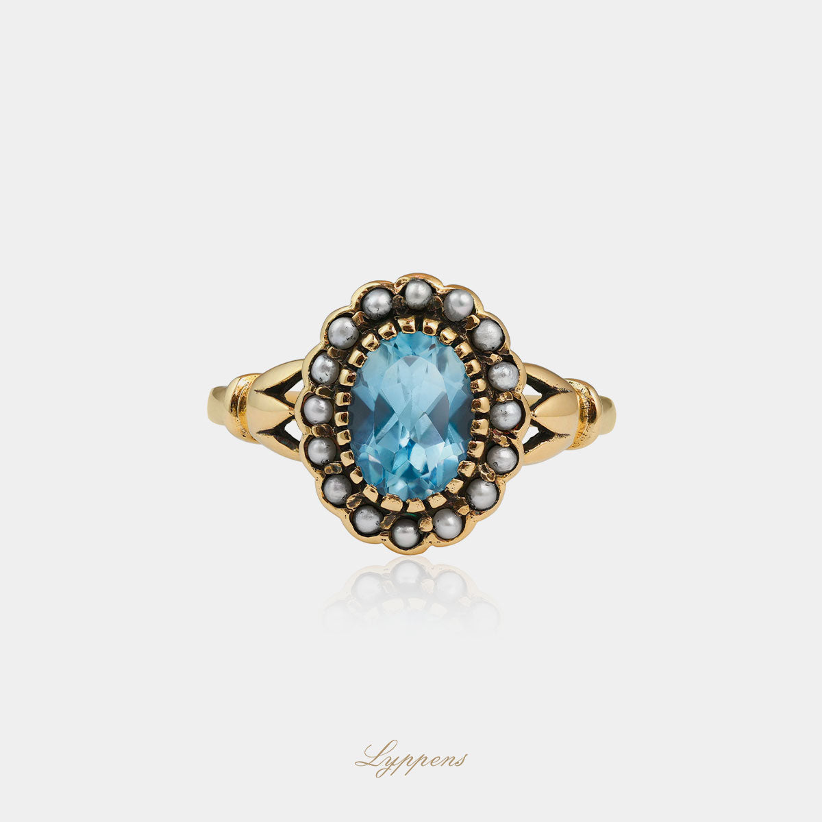 Yellow gold ring with topaz and pearl