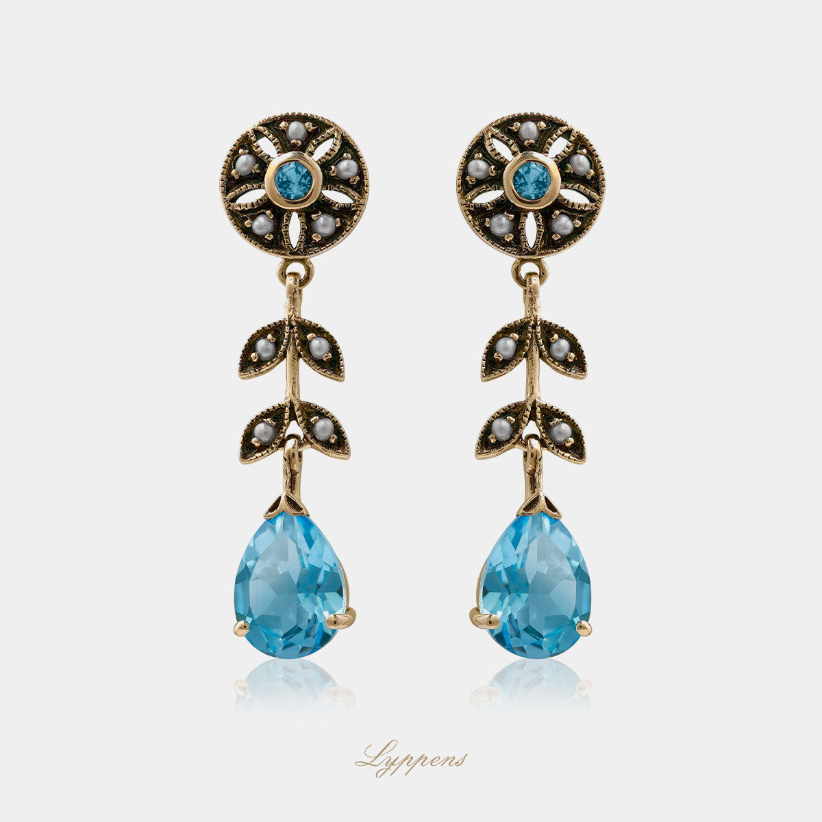 Yellow gold earrings with topaz and pearls