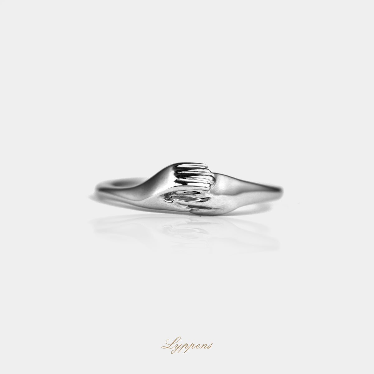 White gold ring with interlocked hands