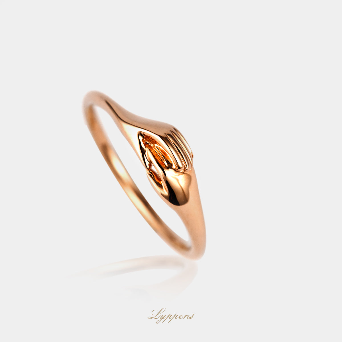 Rose gold ring with interlocked hands