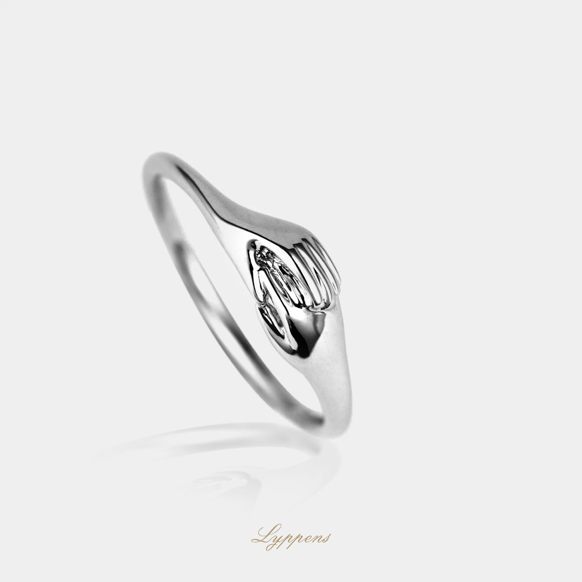 White gold ring with interlocked hands