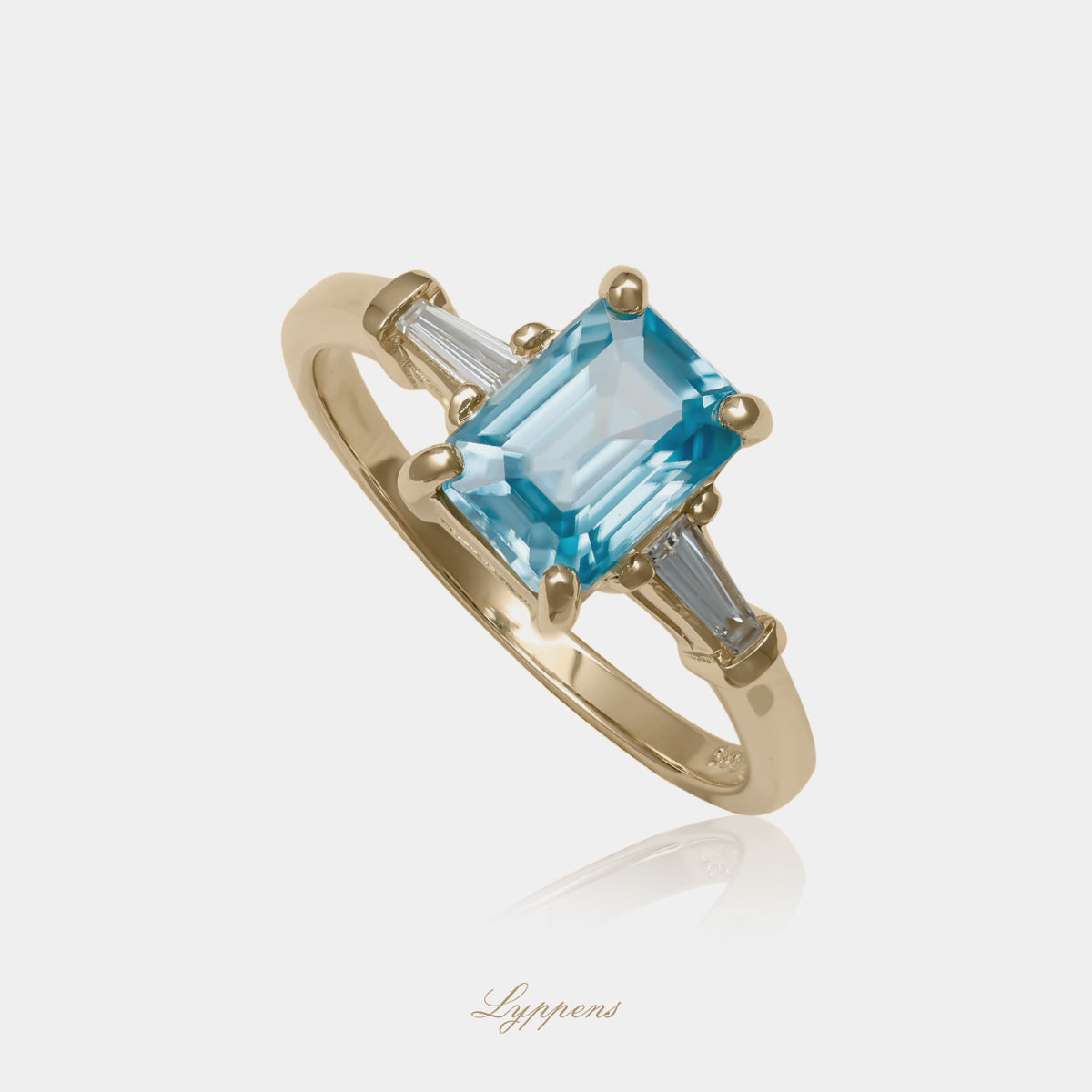 14kt geelgouden verlovingsring met blauwe zirkoon en tapered baguette geslepen diamanten