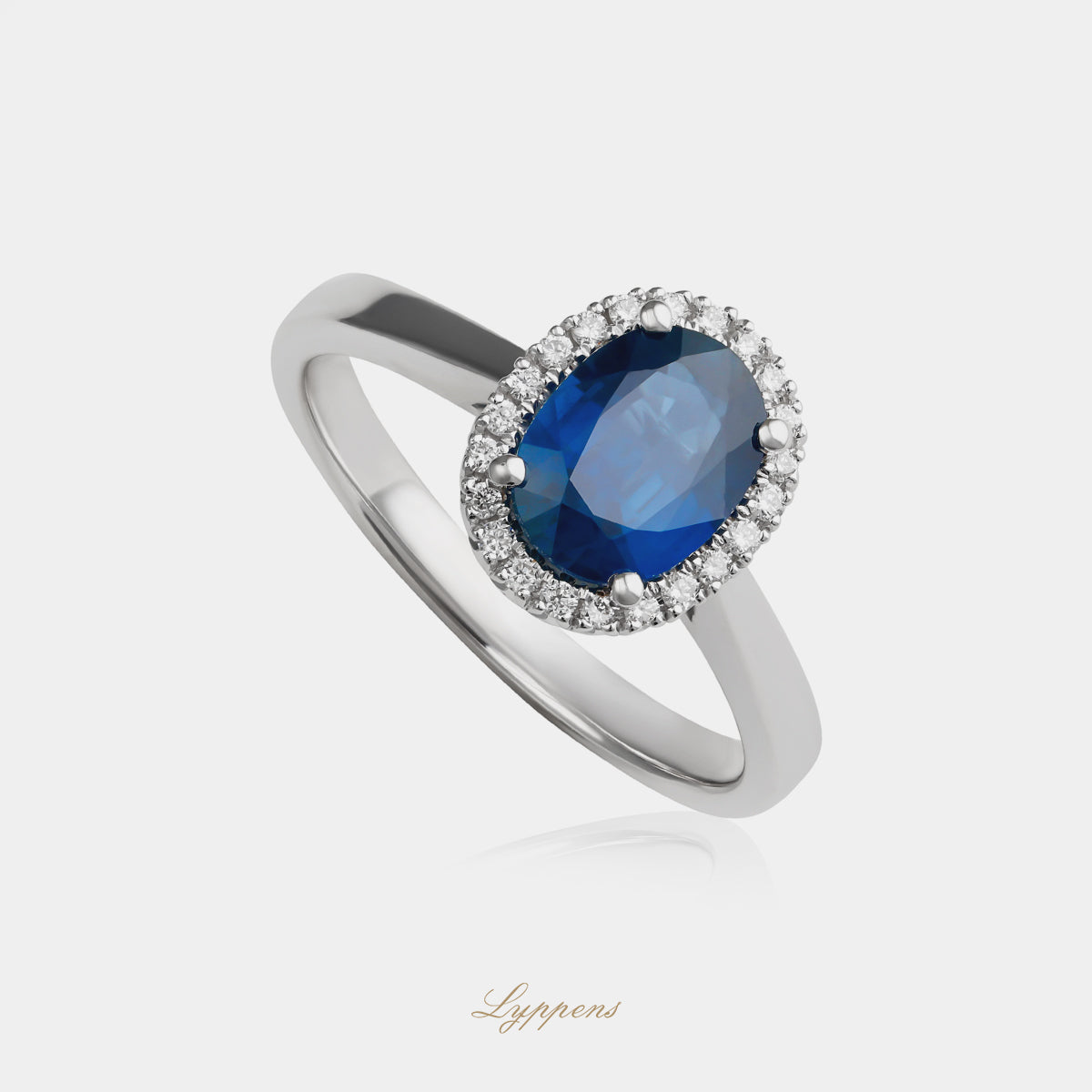 White gold halo ring with sapphire and diamonds