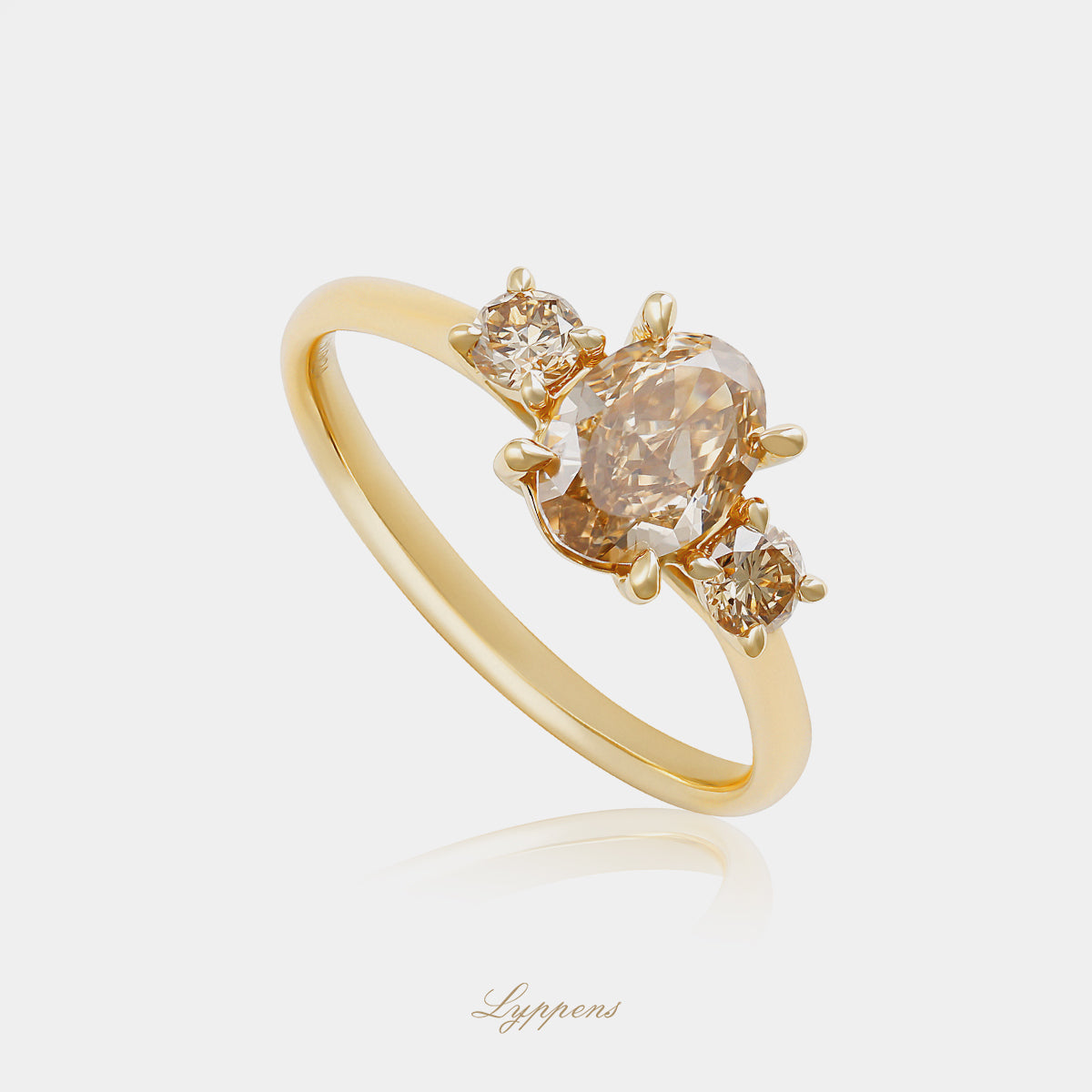 Yellow gold three-stone ring with brown diamonds