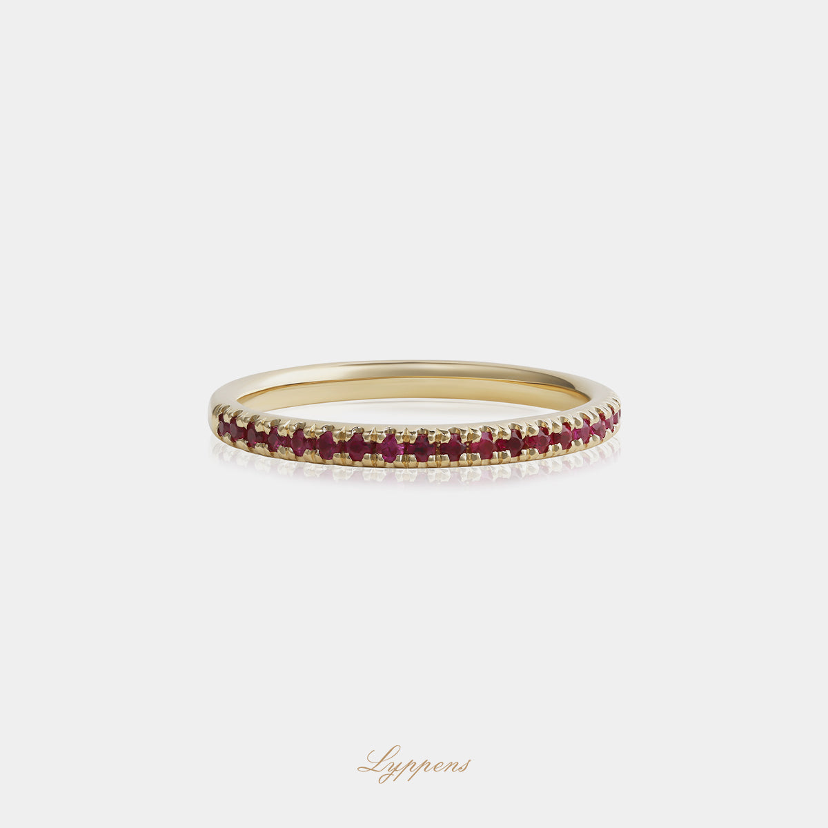 Yellow gold half eternity ring with rubies