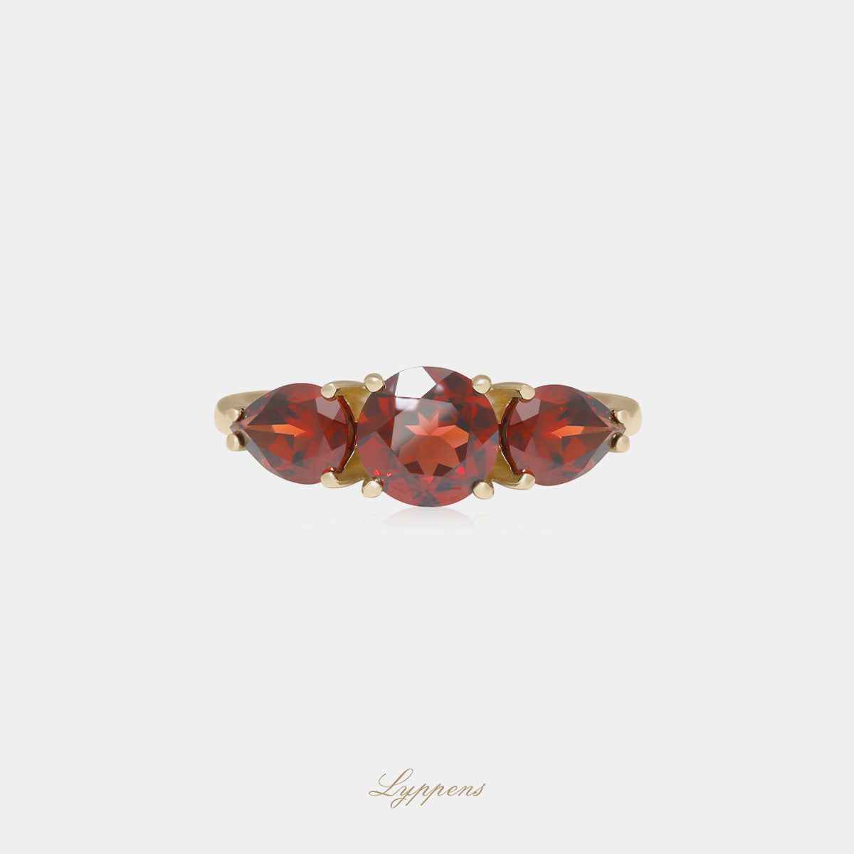 Yellow gold three stone ring with garnet