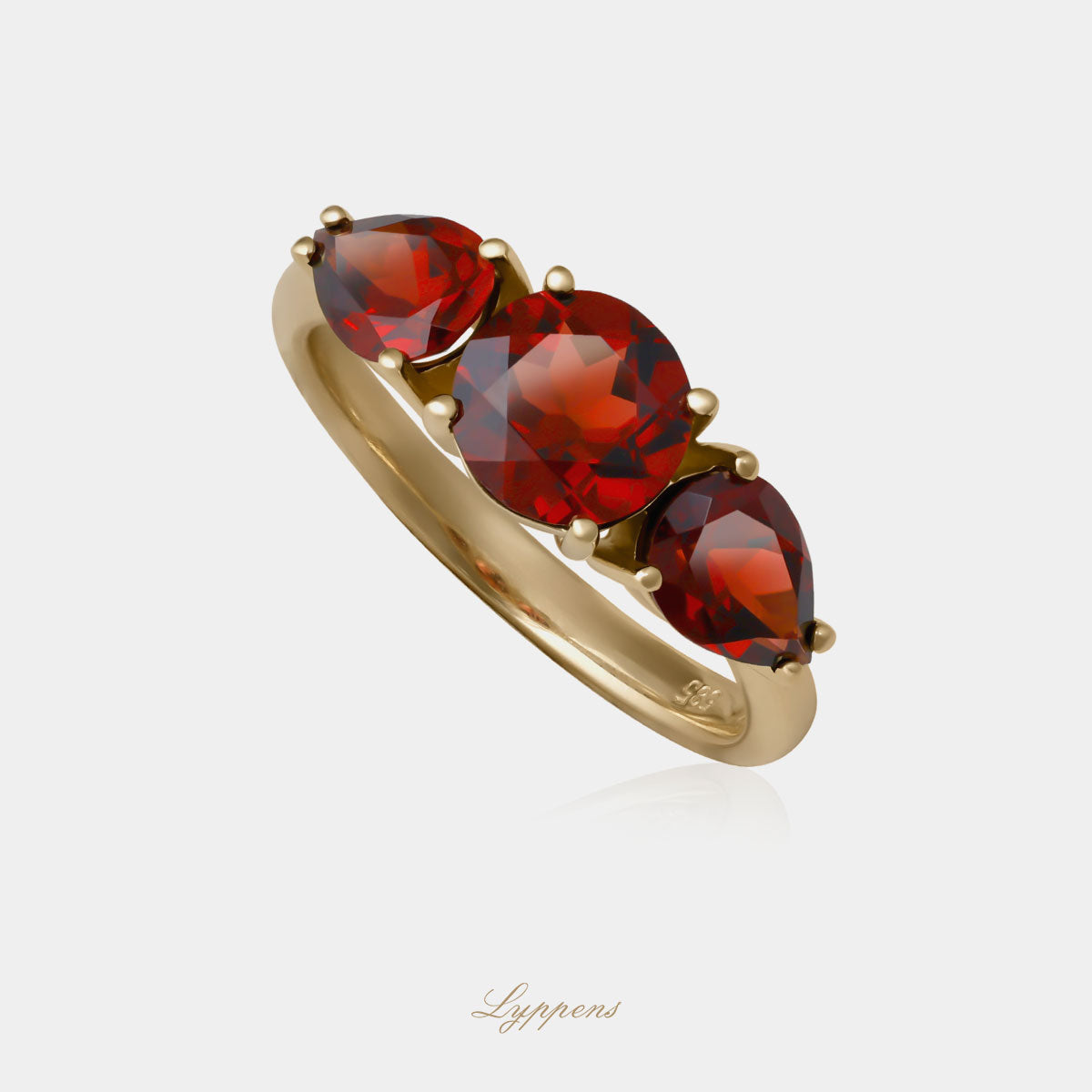 Yellow gold three stone ring with garnet