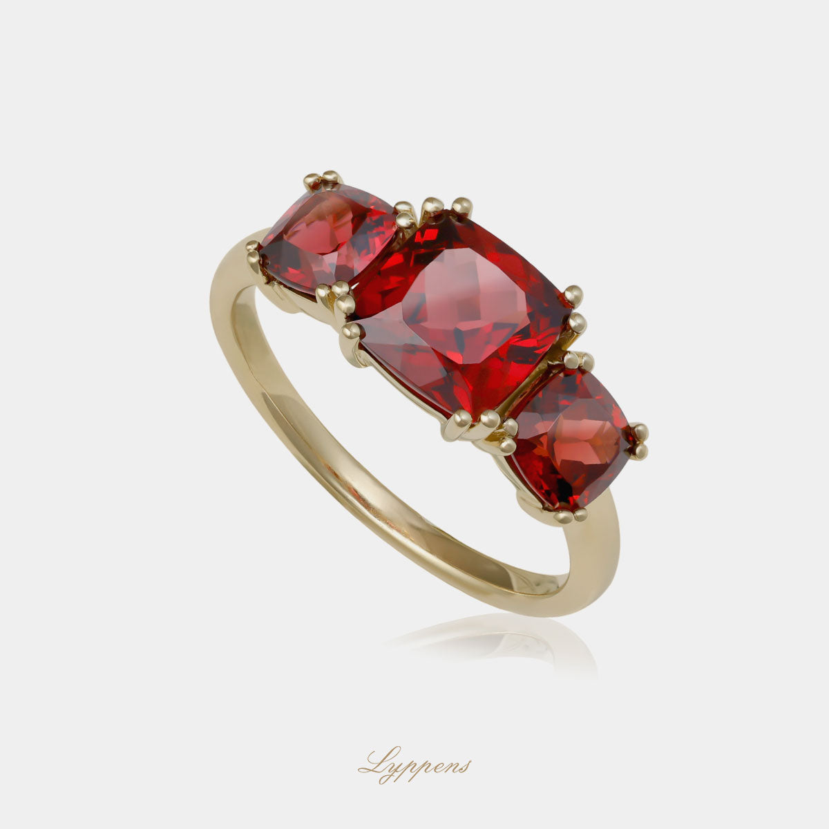 Yellow gold three stone ring with garnet