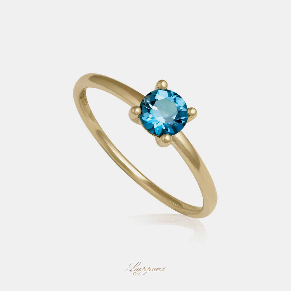 Yellow gold solitaire ring with topaz