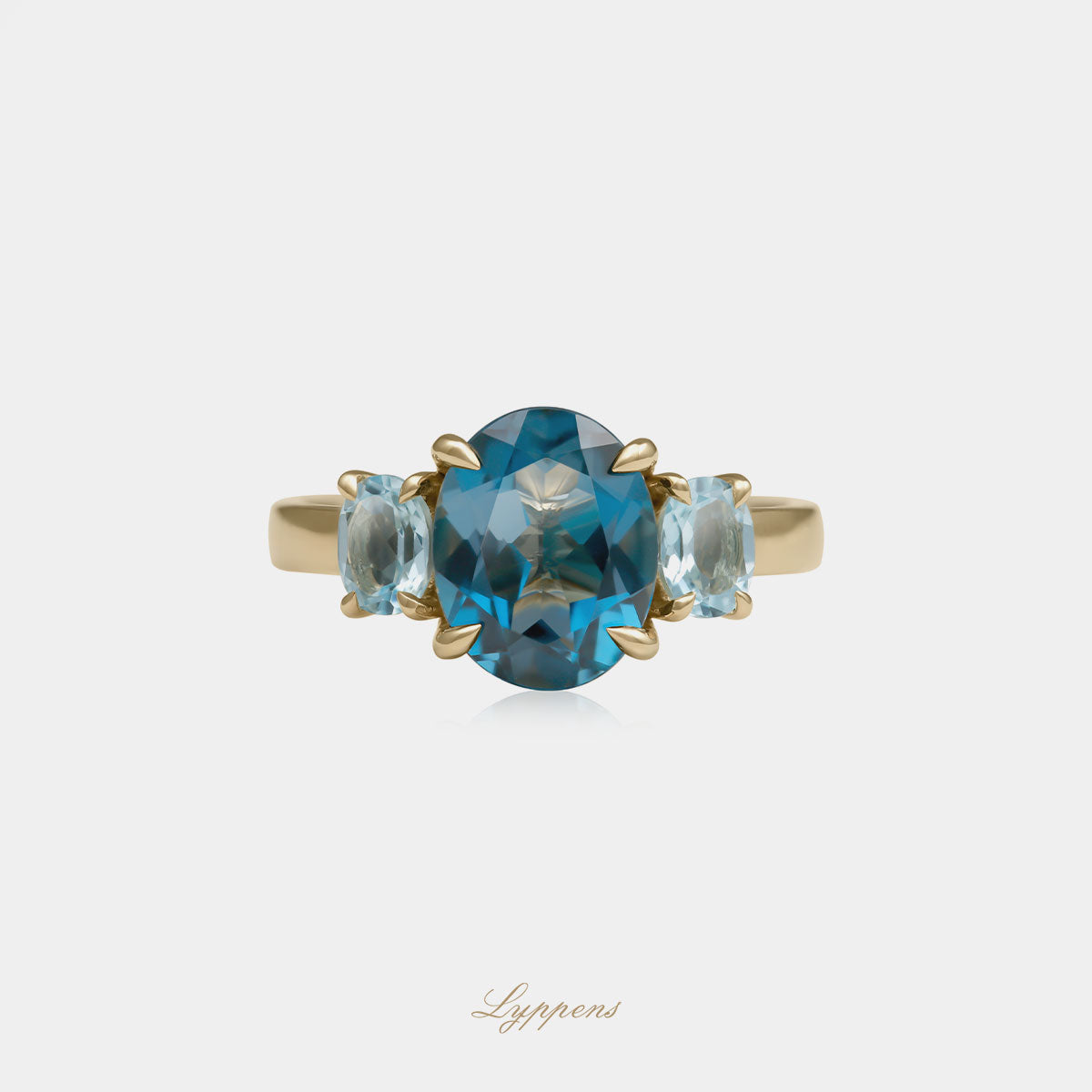 Yellow gold three stone ring with topaz