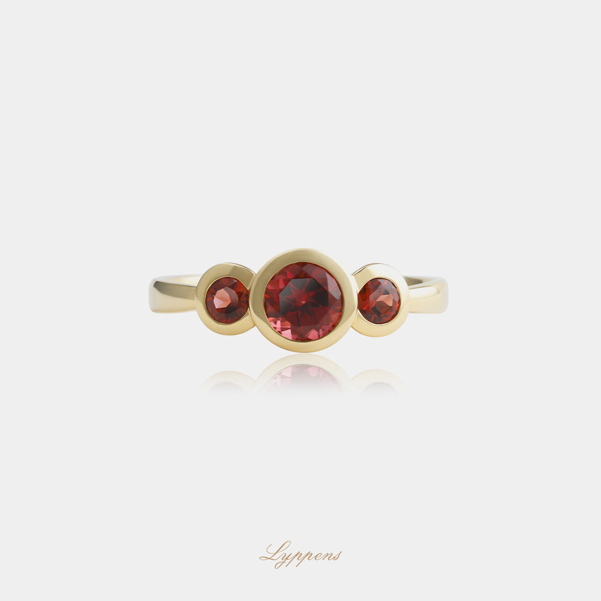 Yellow gold three-stone ring with garnet