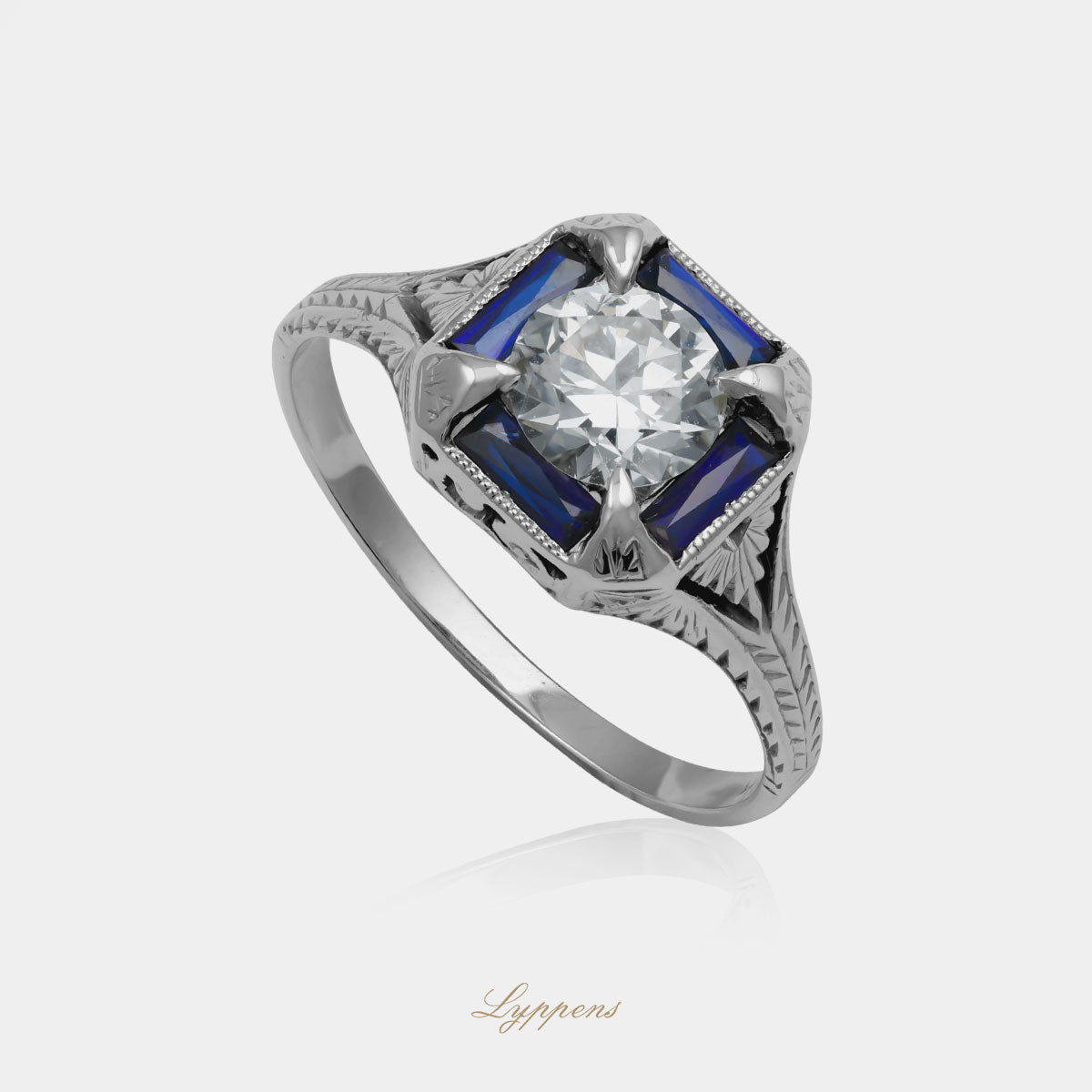 Witgouden vintage Art Deco ring met centrale H/VS diamant van ca. 0.80ct, omringd door saffier in symmetrisch jaren '20 ontwerp.